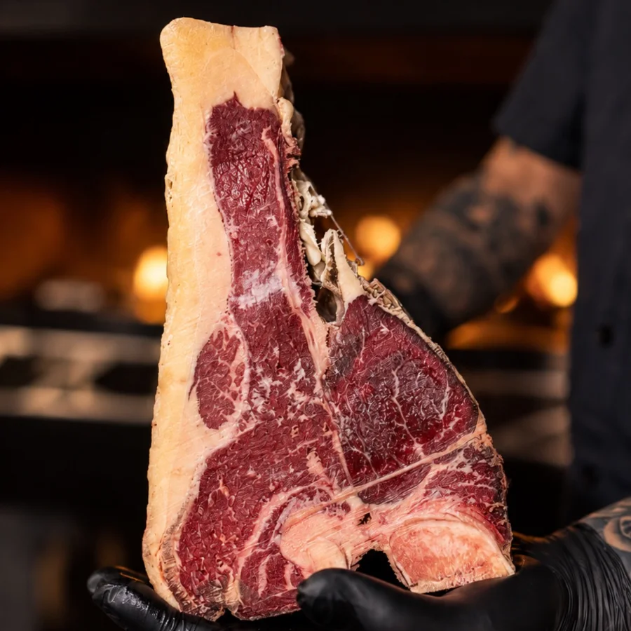 Dry-aged T-Bone with its aging crust, held before going on the grill